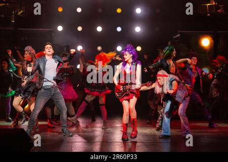 front centre, l-r: Ian McIntosh (Galileo Figaro), Elena Skye (Scaramouche), Ben Elton (The Rebel Leader) in WE WILL ROCK YOU at the London Coliseum, London WC2  07/06/2023 music & lyrics by Queen  story & script: Ben Elton  set design: Stufish Entertainment Architects  costumes & wigs: Kentaur  lighting: Luke Rolls  musical staging: Jacob Fearey  director: Ben Elton Stock Photo