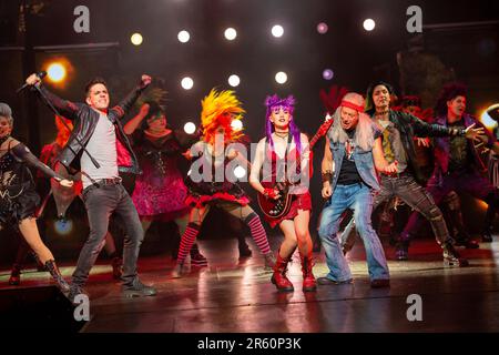 front centre, l-r: Ian McIntosh (Galileo Figaro), Elena Skye (Scaramouche), Ben Elton (The Rebel Leader) in WE WILL ROCK YOU at the London Coliseum, London WC2  07/06/2023 music & lyrics by Queen  story & script: Ben Elton  set design: Stufish Entertainment Architects  costumes & wigs: Kentaur  lighting: Luke Rolls  musical staging: Jacob Fearey  director: Ben Elton Stock Photo