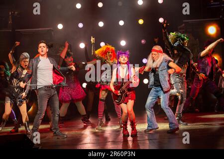 front centre, l-r: Ian McIntosh (Galileo Figaro), Elena Skye (Scaramouche), Ben Elton (The Rebel Leader) in WE WILL ROCK YOU at the London Coliseum, London WC2  07/06/2023 music & lyrics by Queen  story & script: Ben Elton  set design: Stufish Entertainment Architects  costumes & wigs: Kentaur  lighting: Luke Rolls  musical staging: Jacob Fearey  director: Ben Elton Stock Photo