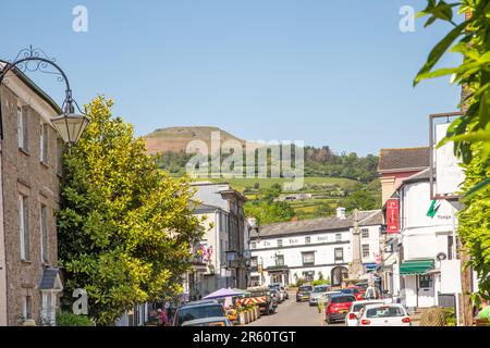 View along High Street in the Powys market town of Crickhowell South Wales with  Table mountain rising above the town Stock Photo