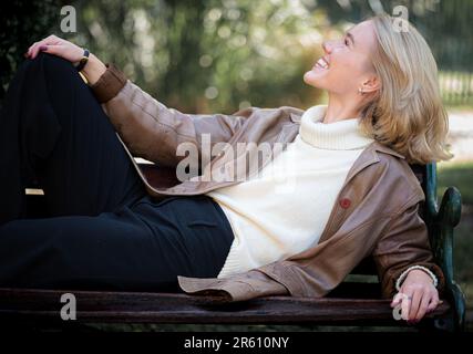 A Caucasian blonde female in leather jacket, posing in a garden Stock Photo