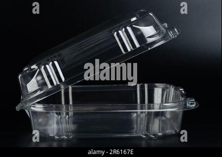 Open plastic food square box side view isolated on black studio background Stock Photo