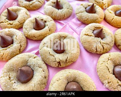 Close up of chocolate candy in homemade cookies on pink paper Stock Photo