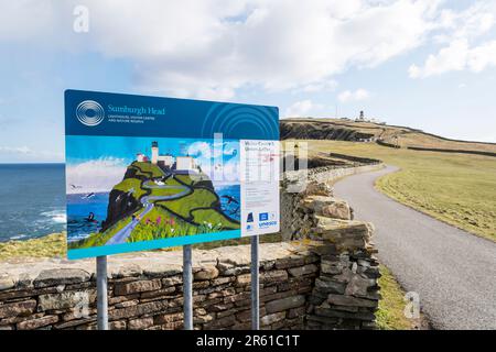 A tourist information sign at Sumburgh Head with the lighthouse in the background. Stock Photo