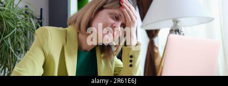 Tired woman working using modern laptop in office Stock Photo