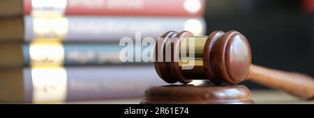 Judge gavel or hammer on sounding block and stack of law books Stock Photo