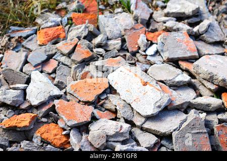 Shattered, broken bricks on nature background. rubble ruin brick building wall broken demolition destruction pile isolated on white background. War Stock Photo