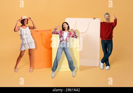 Cheerful multiracial people posing with big colorful shopping bags, collage Stock Photo