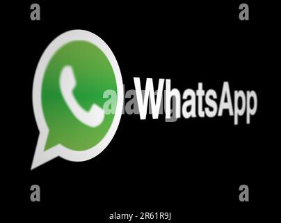 Menlo Park, US, May 2023: WhatsApp logo on a black background. Freeware, cross-platform, centralized instant messaging and voice-over-IP service. Illu Stock Photo