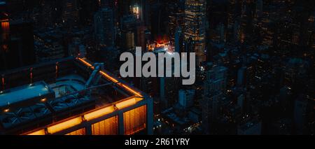 Aerial view of the iconic Times Square in New York City during the evening, showing the brightly lit buildings and streets between them Stock Photo