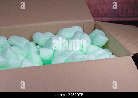 Packing chips, filling material in cardboard box Stock Photo