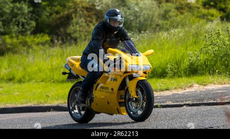 Stony Stratford,UK - June 4th 2023: 2001 yellow DUCATI 996 BIPOSTO  classic motorcycle travelling on an English country road. Stock Photo
