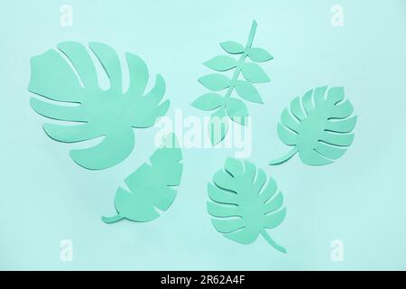 Different tropical leaves on pale turquoise background Stock Photo