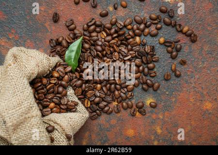 Sack bag with coffee beans on grunge background Stock Photo