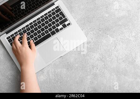 Female hand with modern laptop on light background Stock Photo