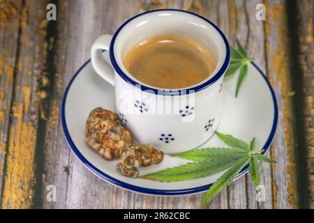Marijuana light green leaf on blue white cup Stock Photo