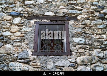 A close up of a vintage window with a decorative wrought iron grille Stock Photo