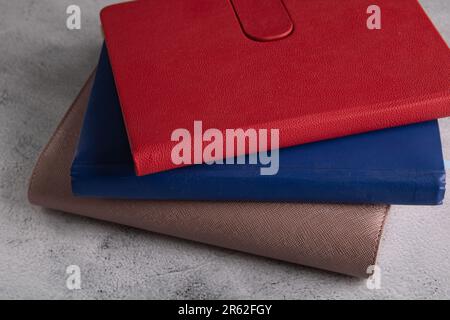 a photo of several notebooks of different colors lying on the table Stock Photo