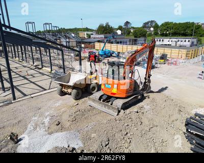 Church Village, Pontypridd, wales - May 2023: Mini excavator and dumpoer truck on the site of a new primary school being built in south Wales. Stock Photo