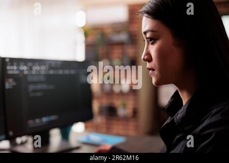 System engineer writing html code and javascript on terminal window, working with computer displaying coding algorithm. Asian database programer programming big data in company office. Stock Photo