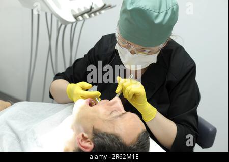 dental anesthesia in dentist's chair, needle of syringe, infiltration anesthesia, conductive local anesthesia in dentistry Local infiltration insulin syringe Stock Photo