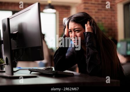 Tech engineer was feeling the effects of exhaustion while typing programming code on computer to develop online cloud computing information. Web programer writing html script and data algorithm Stock Photo