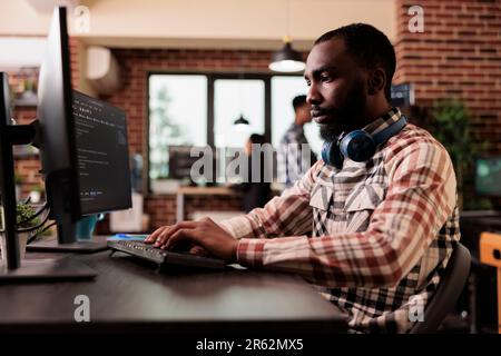 Freelance coder typing javascript code on computer to develop online cloud computing information. Software developer writing html script and data algorithm, working in it programming office Stock Photo