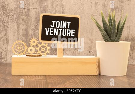 Black color banner that have embossed letter with word venture on white paper background Stock Photo