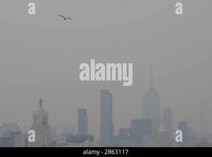 New York, United States. 06th June, 2023. The Manhattan skyline is barely visible hours before sunset as it is enveloped in smoke from continued wildfires in Canada on Tuesday June 6, 2023 in New York City. Millions of people in the eastern United States faced unhealthy air quality conditions on Tuesday, as smoke from wildfires in eastern Canada wafts over much of the country. Photo by John Angelillo/UPI Credit: UPI/Alamy Live News Stock Photo