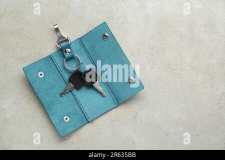 Stylish leather holder with keys on light grey table, top view. Space for text Stock Photo