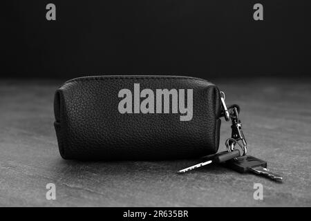 Leather case with keys on grey table, closeup Stock Photo