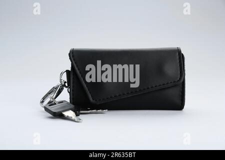 Leather case with keys on light grey background Stock Photo