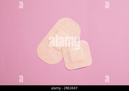 Contraceptive patches on pink background, top view Stock Photo