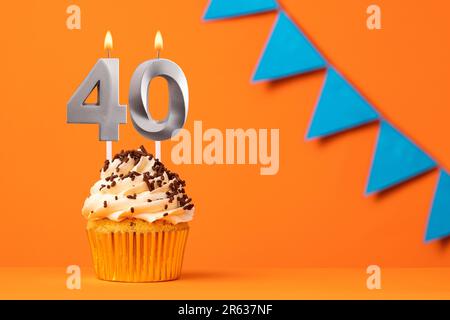 Birthday cake with candle number 40 - Orange background Stock Photo