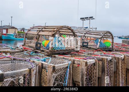 Lobster traps are assembled on the wharf in Glace Bay Nova Scotia ready to be loaded onto boats for the next run. Stock Photo