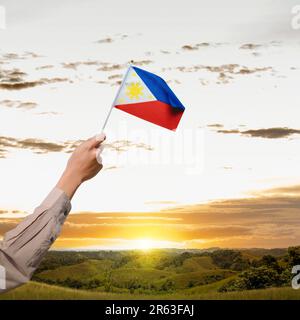 A human hand holding a Philippine flag. Philippines Independence Day concept Stock Photo