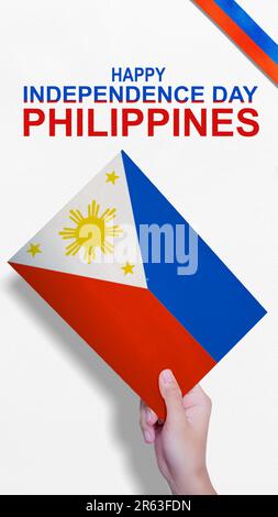 A human hand holding a Philippine flag. Philippines Independence Day concept Stock Photo