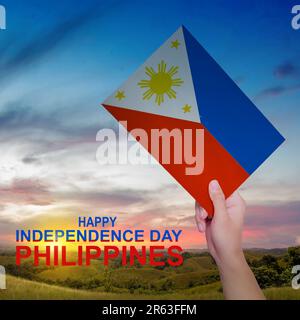 A human hand holding a Philippine flag. Philippines Independence Day concept Stock Photo