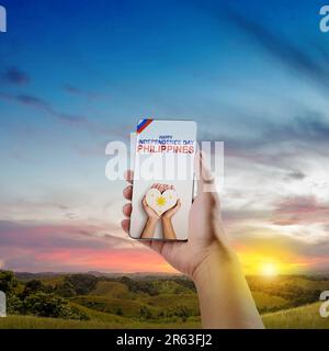 A human hand is holding a heart with the Philippine flag color. Philippines Independence Day concept Stock Photo