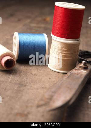 Old vintage sewing tools on a wooden table, selective focus Stock Photo