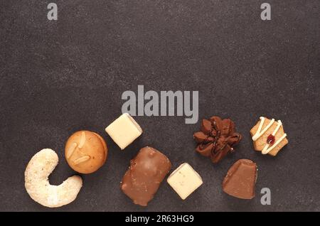 Christmas cookies on a dark stone plate, view from above with space for text, seasonal holiday food Stock Photo
