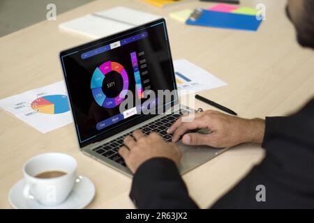 Analyst working with business analytics and data management system on computer, make a report with KPI and metrics connected to database. Corporate st Stock Photo