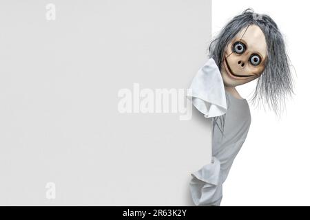 Scary Momo standing behind the wall on white background. Scary face for ...