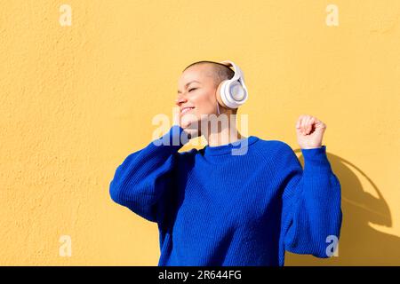 woman dancing listening to music in her headphones Stock Photo