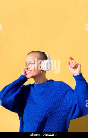 woman dancing listening to music in her headphones Stock Photo