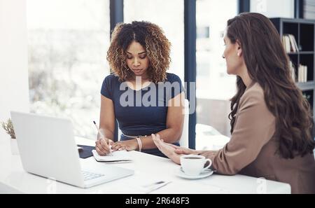 Theyre pros at being productive. two businesswomen collaborating on a project at work. Stock Photo