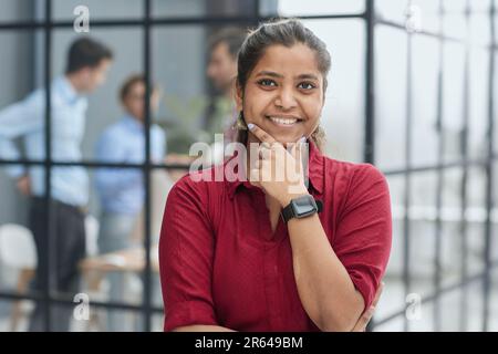 Front portrait of pretty young woman in office Stock Photo