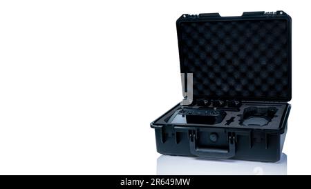 Drone and accessories in plastic case isolated on white background. UAV or unmanned aerial vehicle and drone accessories in protective travel case. Stock Photo