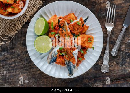 Fried mackerel with spicy sauce and bomay potatoes Stock Photo