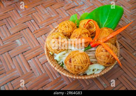 Deep fried wrapped pork with noodle. Traditional thai food as known as Mhoo Sarong. Stock Photo